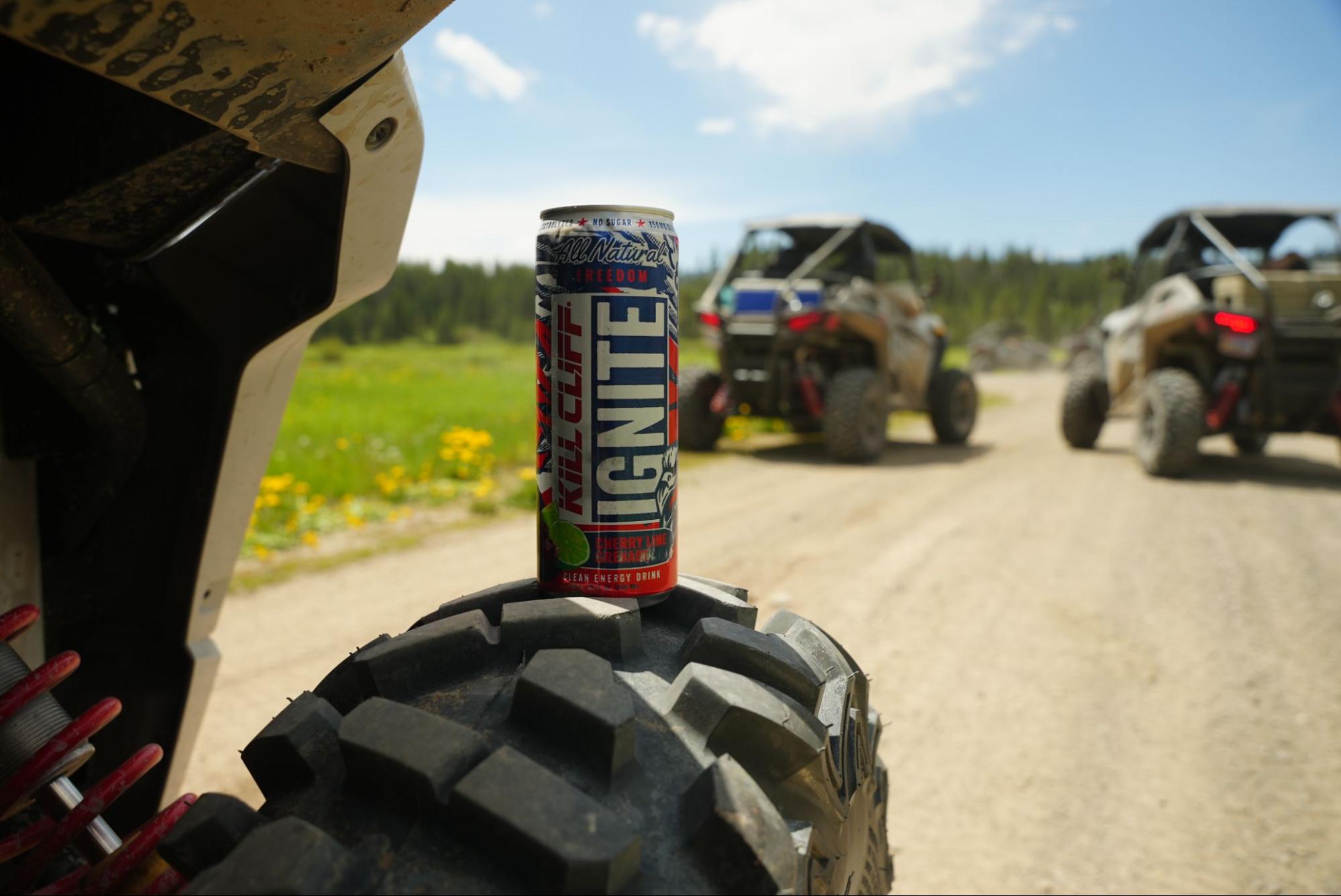 A can of Kill Cliff beverage against the backdrop of ATVs.