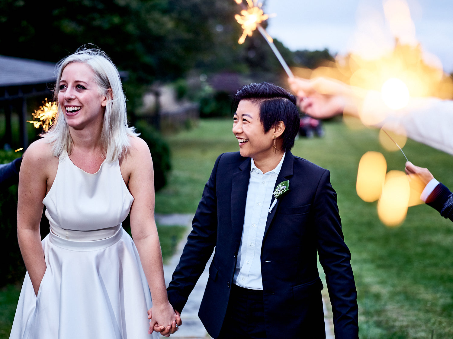 A couple in a wedding setting wearing some of the clothing from Kirrin Finch.