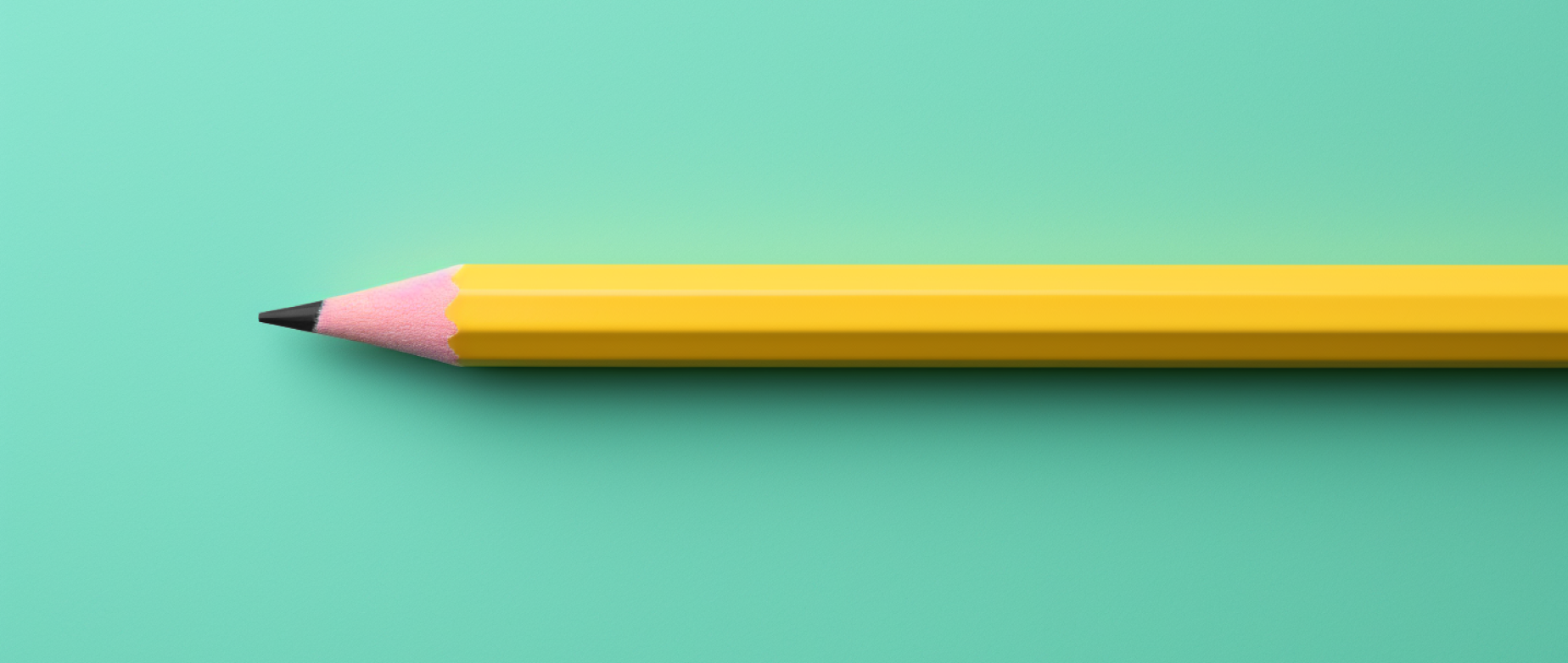 A yellow wooden pencil on a teal background.