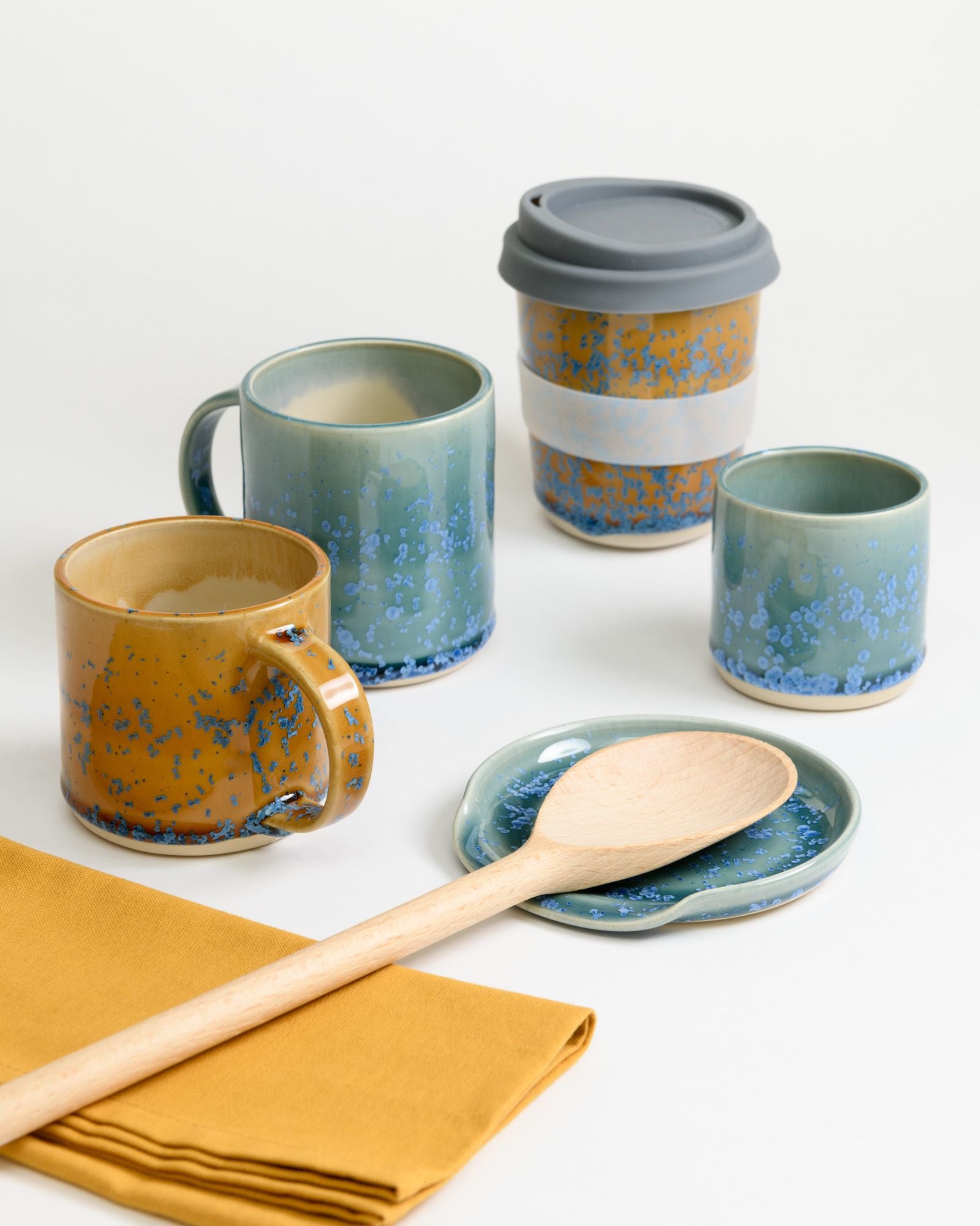  A selection of mugs, travel cups, and spoon rest made by Raquel Acosta.