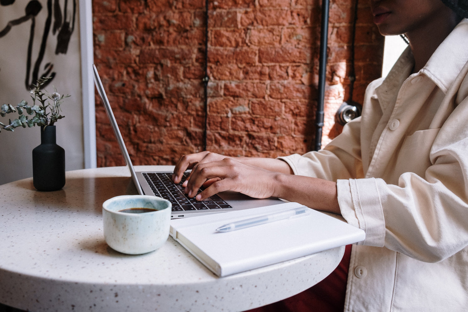 A person types on a laptop in a home setting