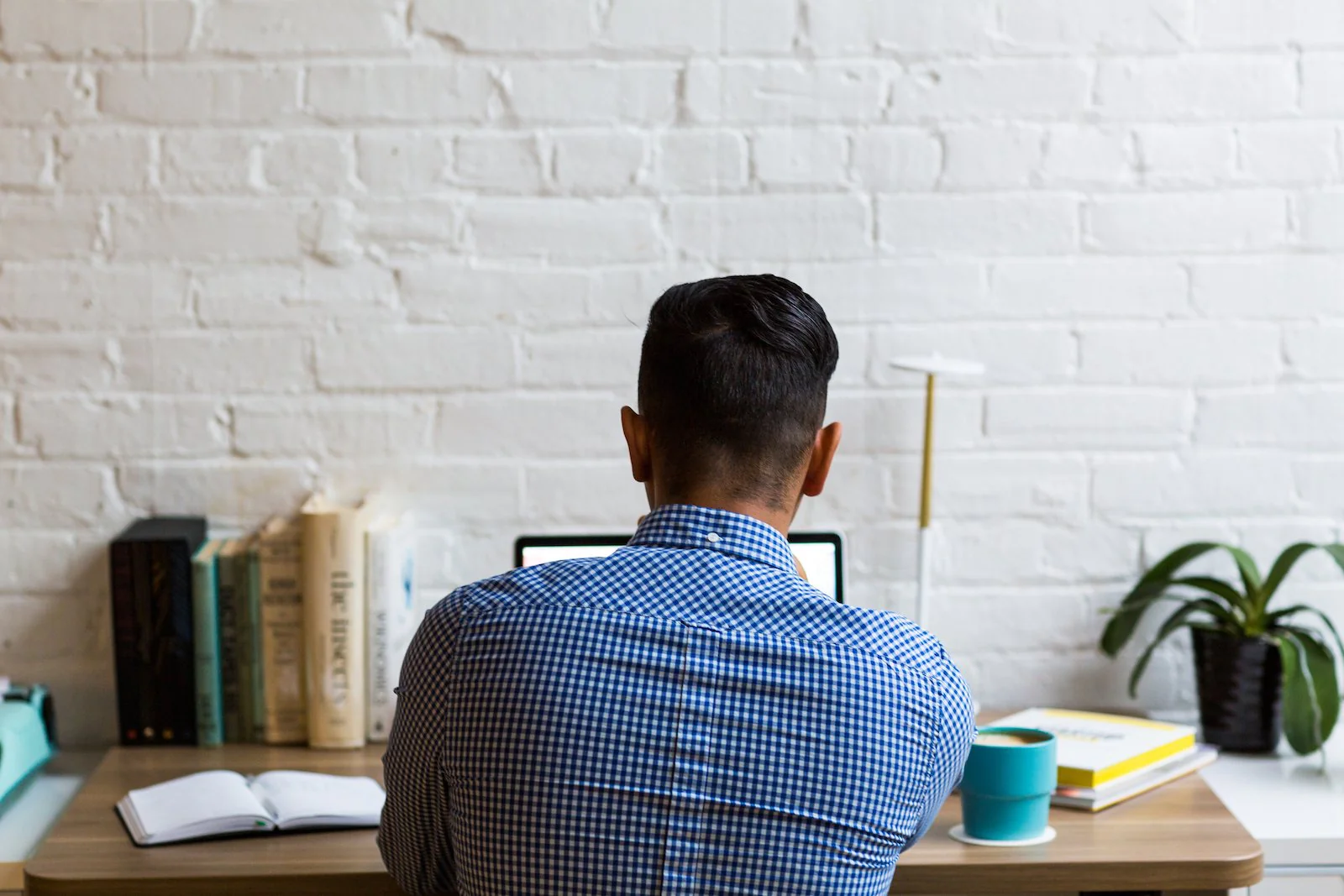 Image of a man sitting at a desk browsing the internet looking for business opportunities at home