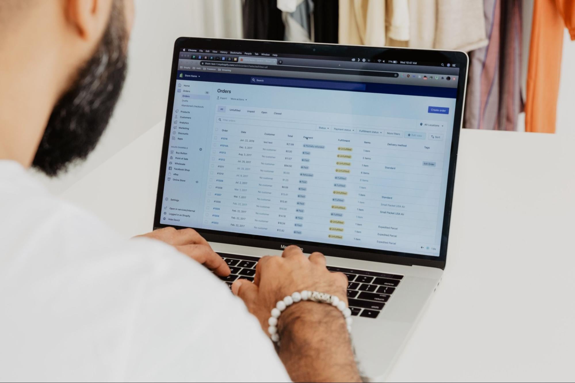 An entrepreneur sits at a table working on their online store.