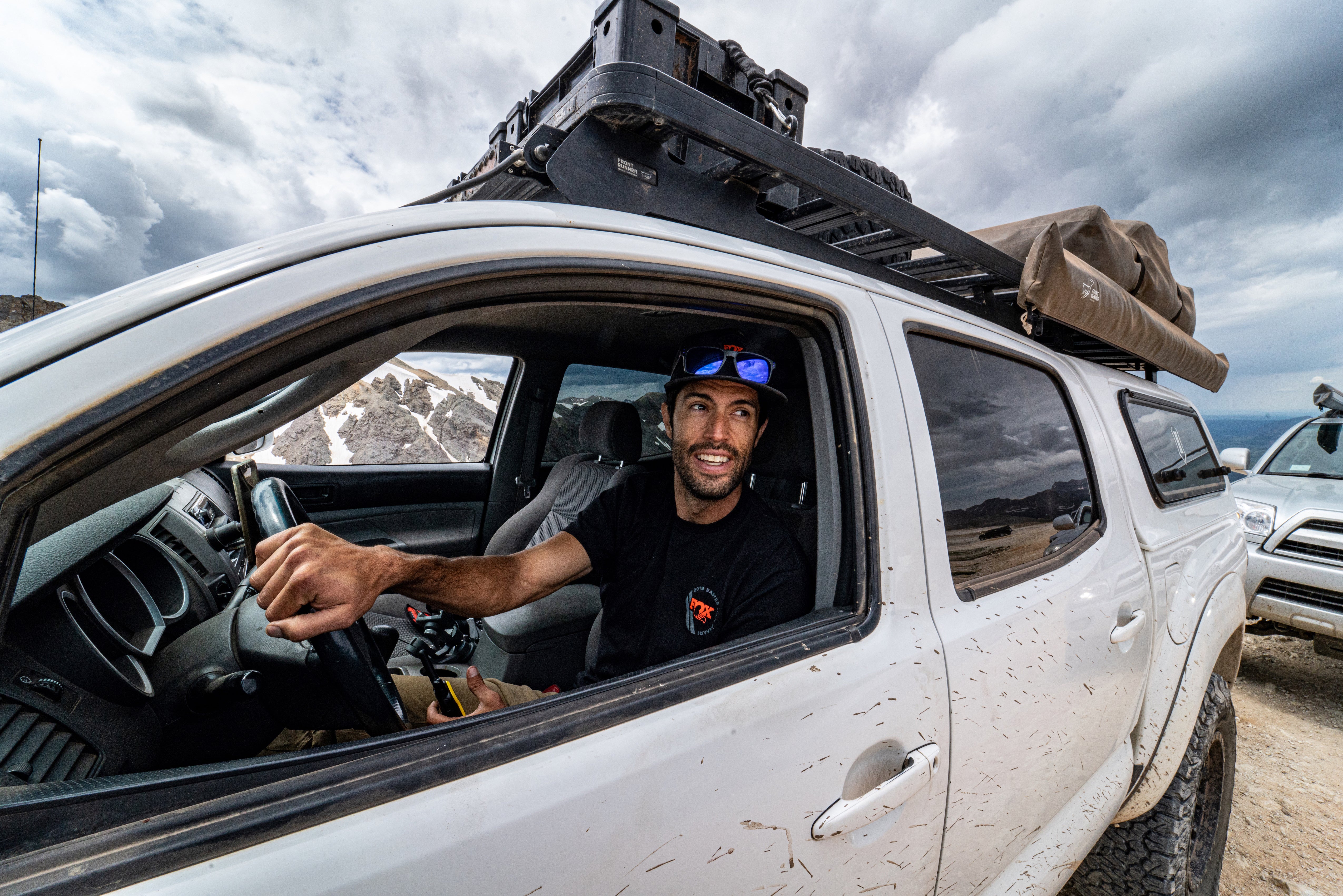 Founder Sean Reyes sitting in the driver seat of a car with the window down. 