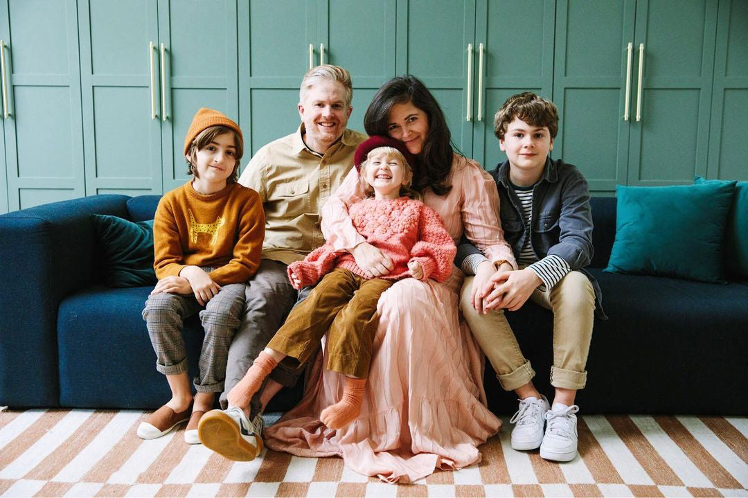 Jordan Ferney and her family of five pose on a couch