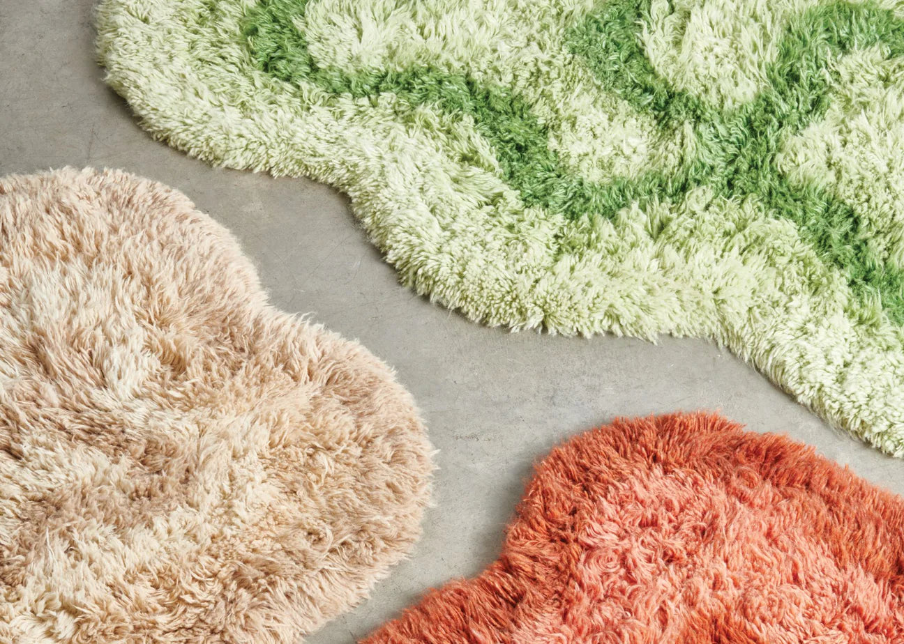 Several organic shaped rugs on a floor