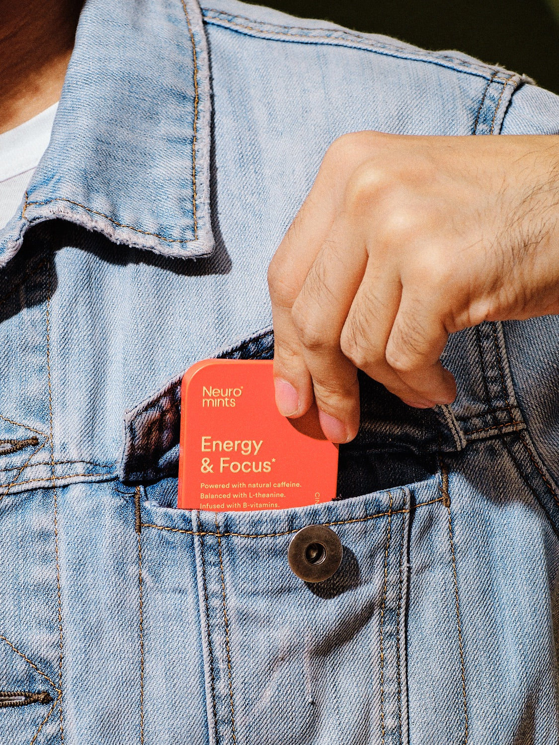 A box of Neuro mints being pulled out of a jean’s jacket pocket. 