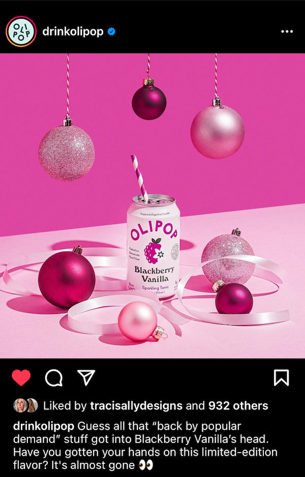 An Instagram post from Olipop features a can of blackberry vanilla with holiday baubles around it