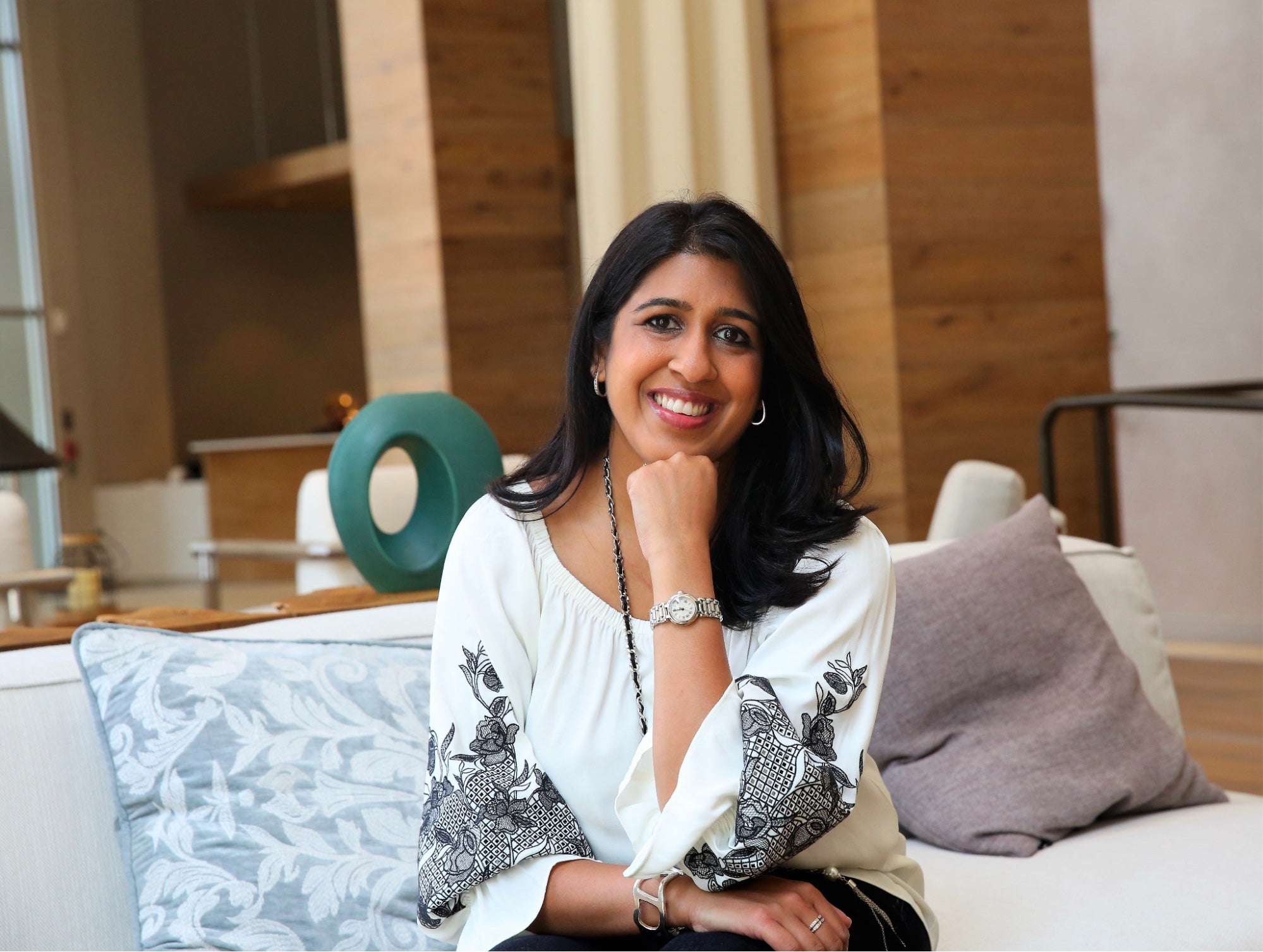 Amy Divaraniya, the founder of OOVA in a living room setting
