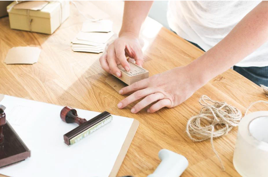 Image of person preparing a package for international shipping.