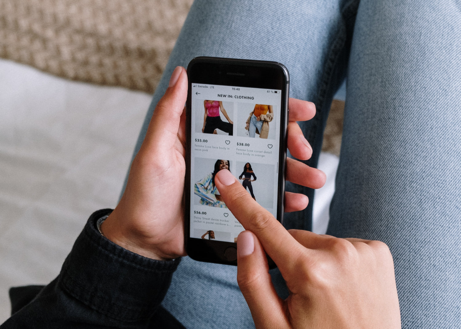 A hand browses on a mobile phone on an ecommerce store 