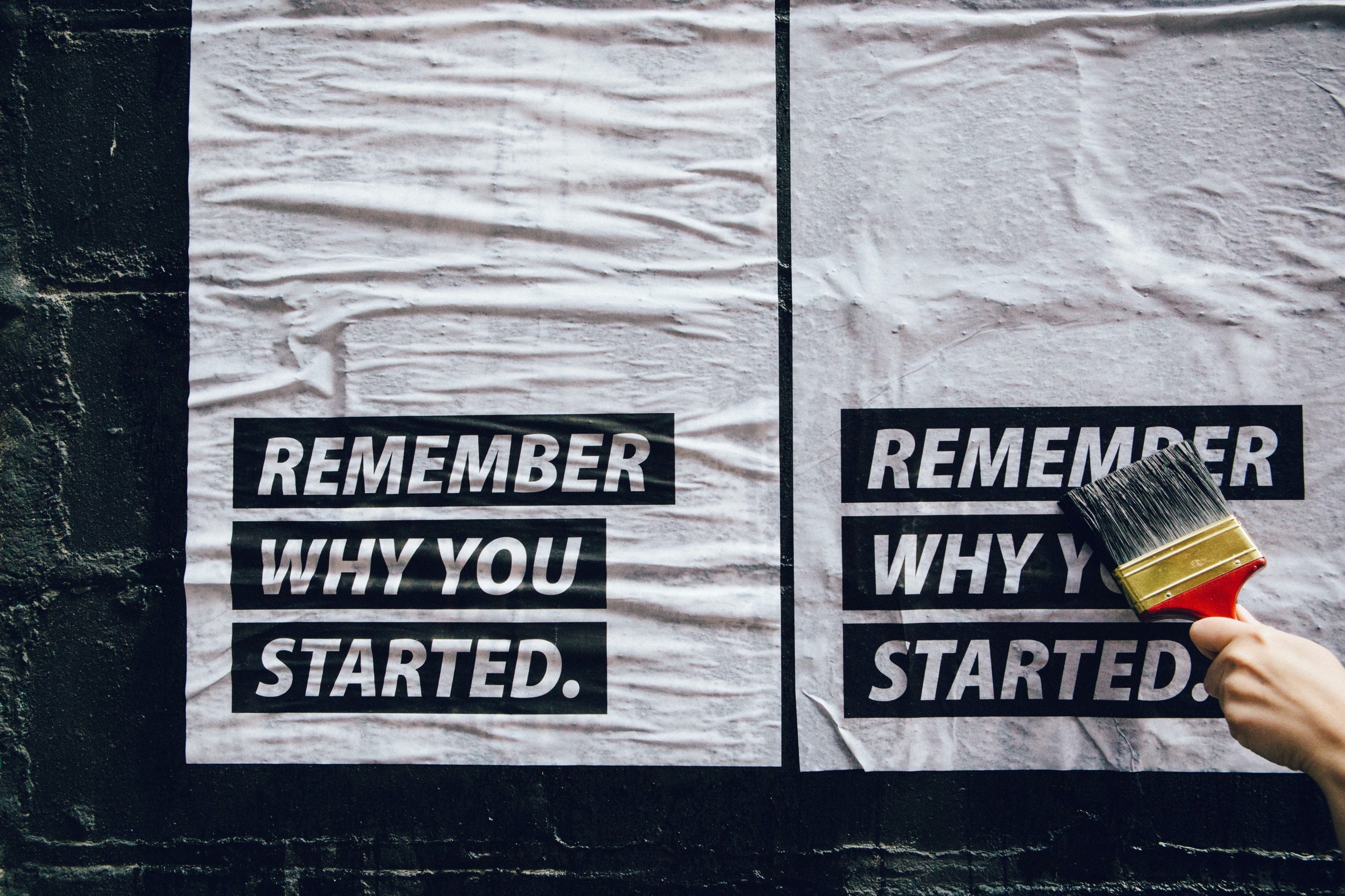 Motivational posters on a wall that read "Remember why you started"