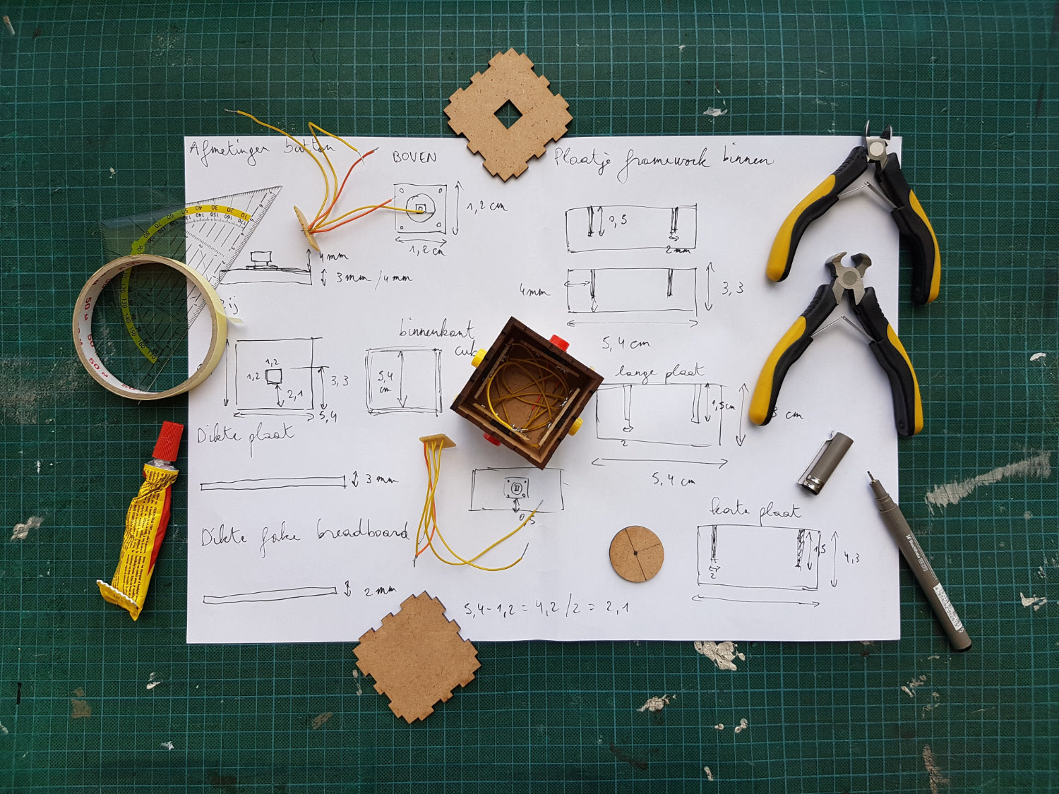 A number of product drafting tools lay on a work surface