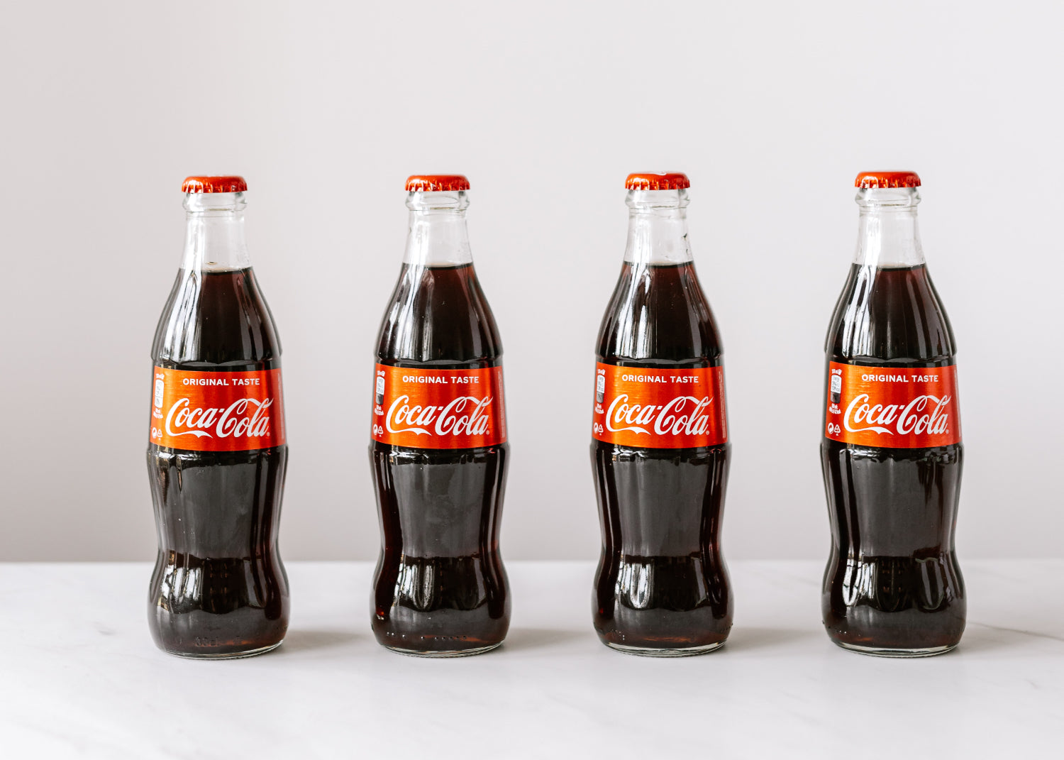 A row of glass Coca-Cola bottles