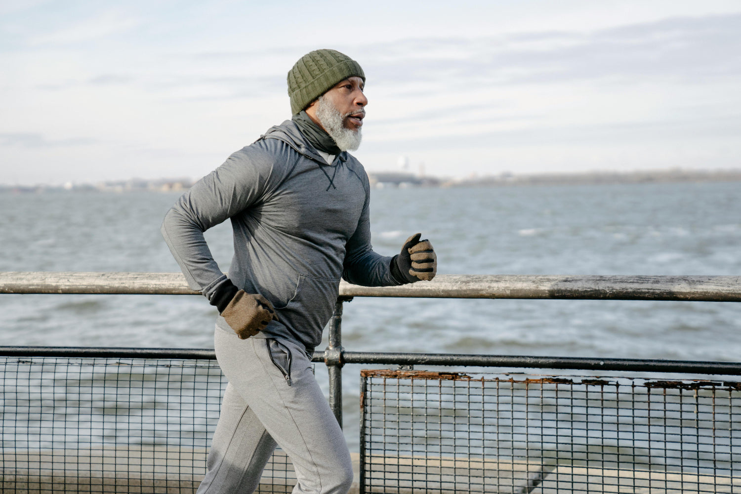 An older man runs beside the coast