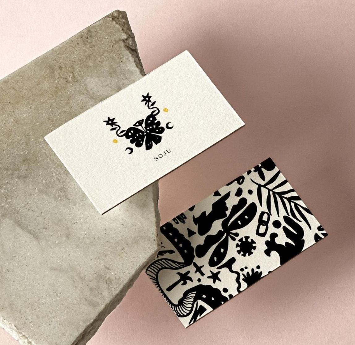 Illustrated business card on a white background with bold patterns on one side.