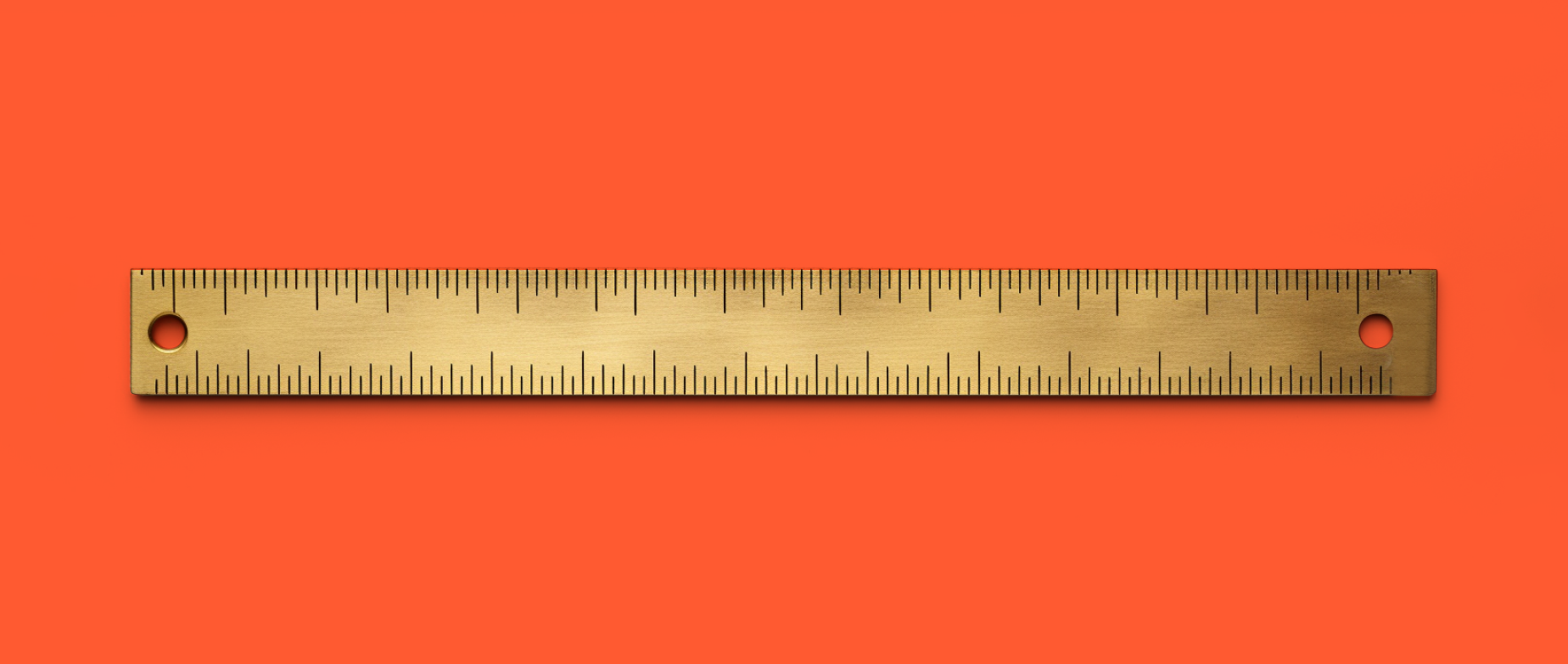 A wooden ruler on an orange bakcground.