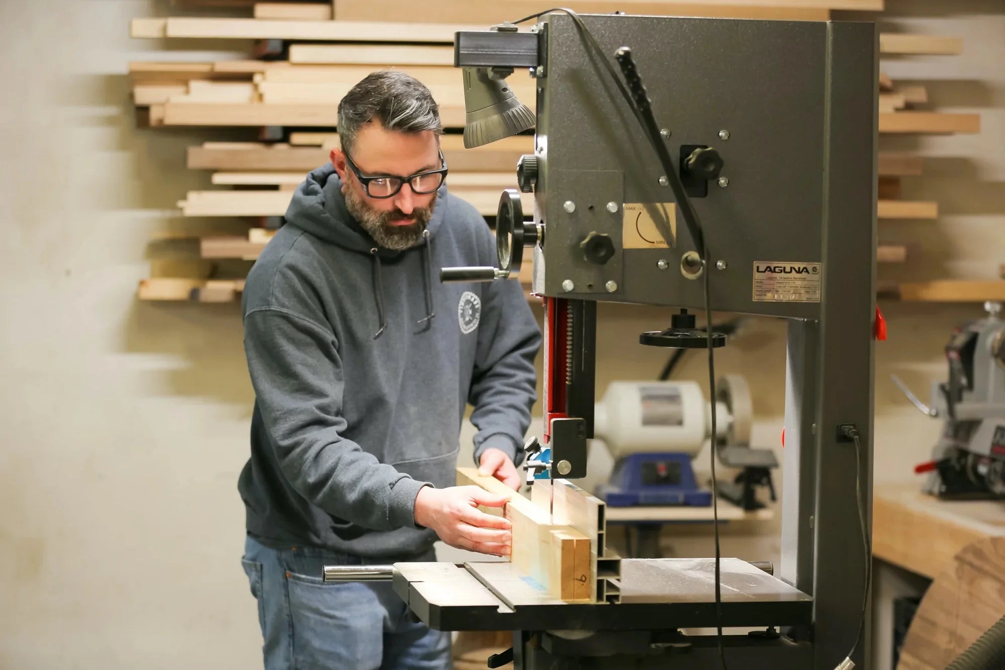 A man works on a wood project in a workshop