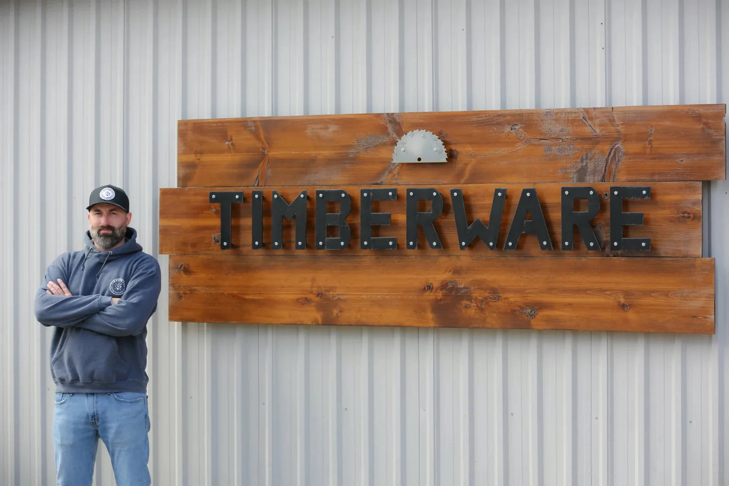 Portrait of Timberware founder, Paul Trepanier standing in front of a store sign