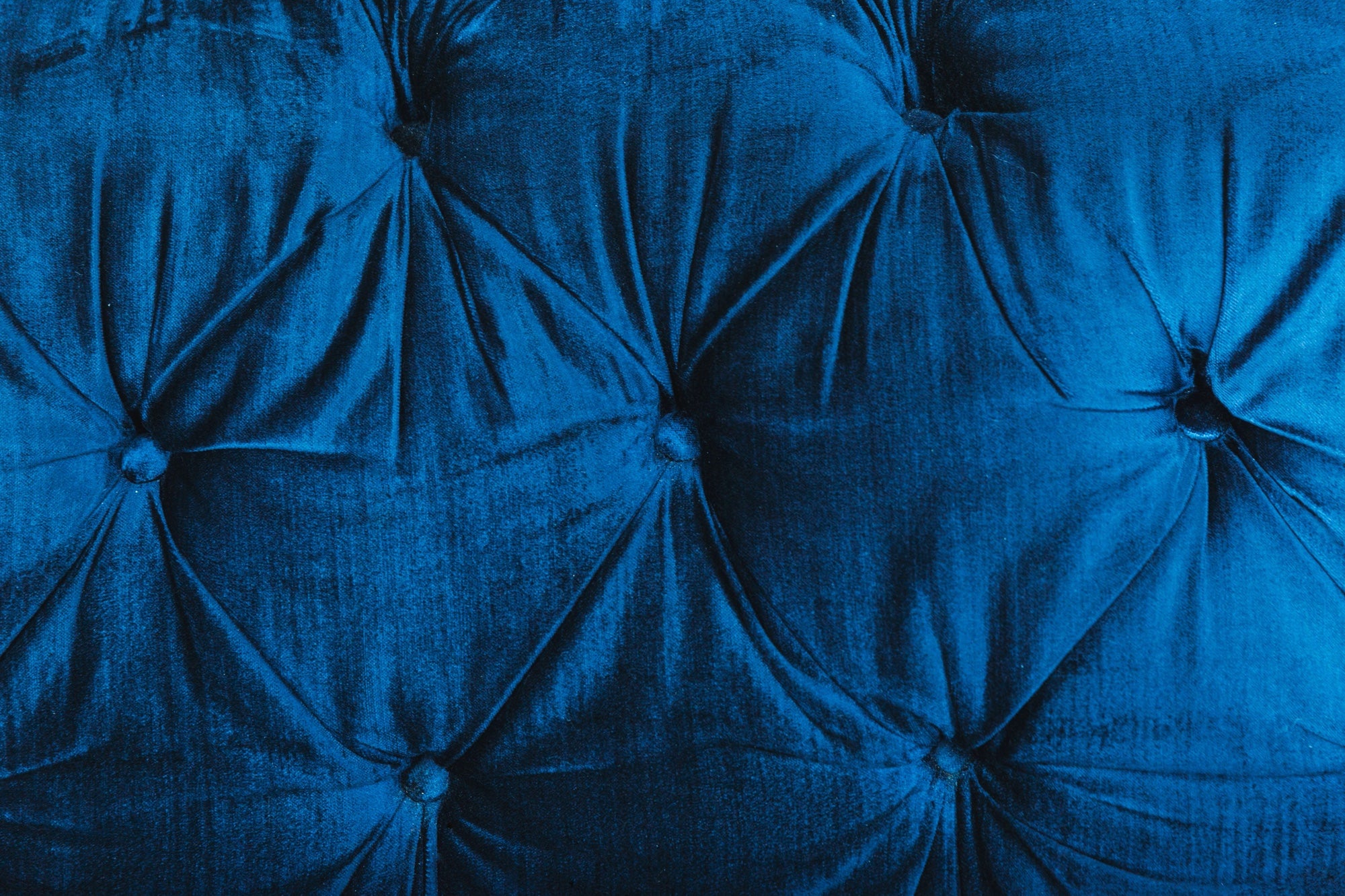 Texture detail of a blue upholstered velvet couch