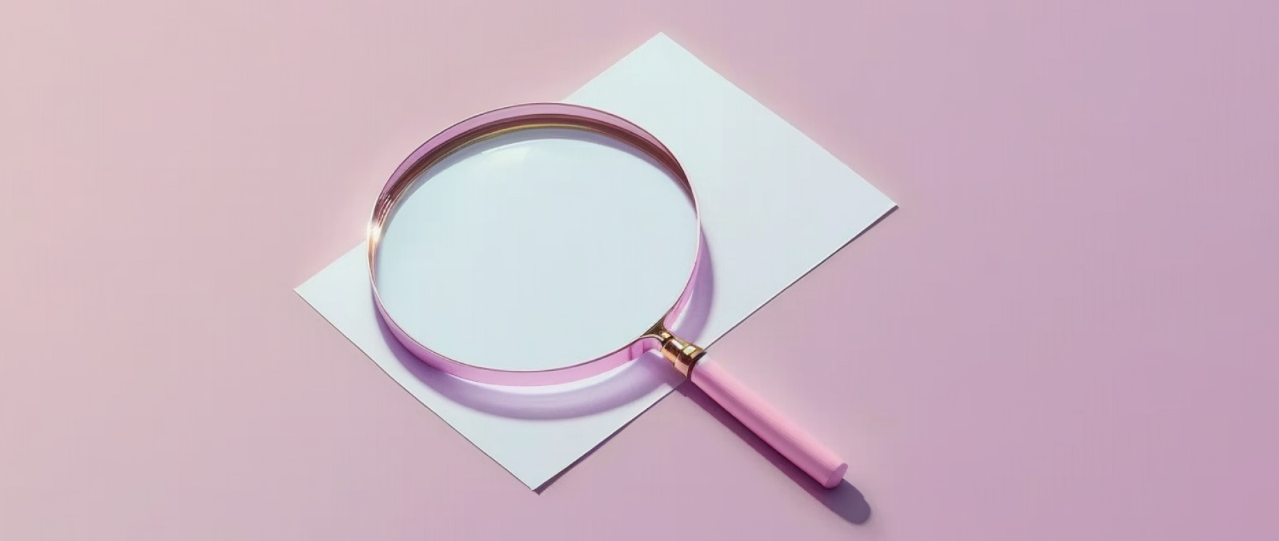 a magnifying glass laying down on a blank piece of paper: seo copywriting
