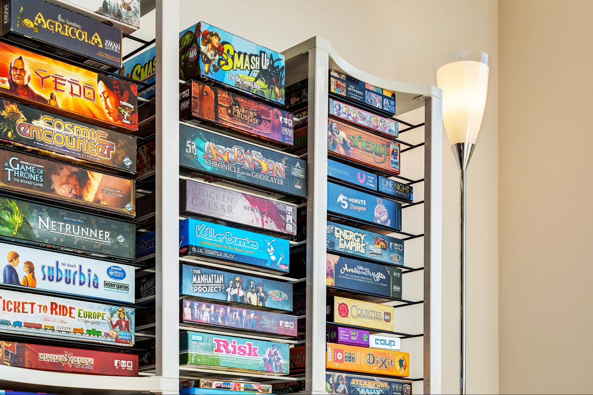 A selection of board games on shelves by BoxThrone. 