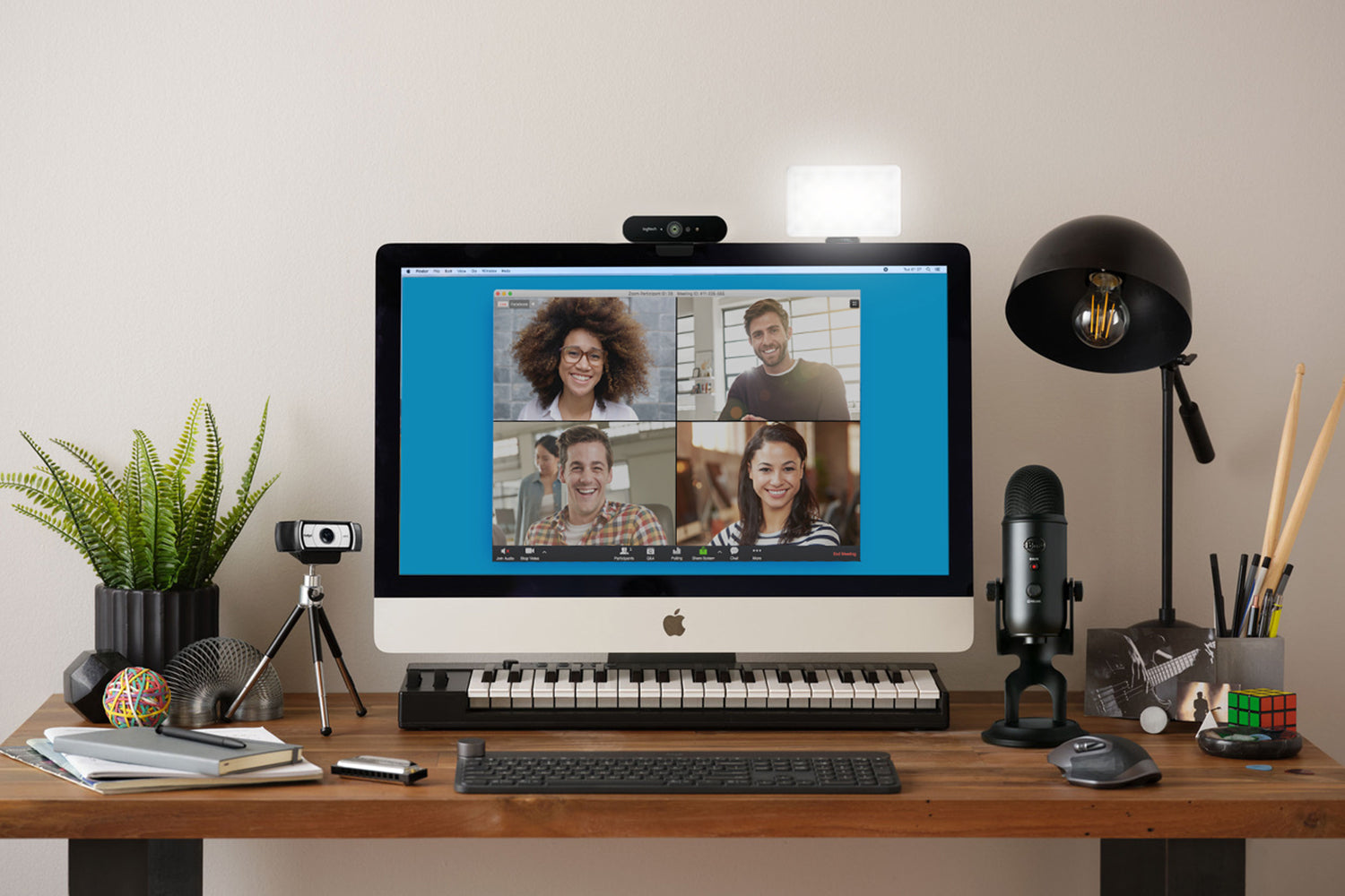 A desk setup with carious cameras, mic, keyboard attachments along with a light from Lum