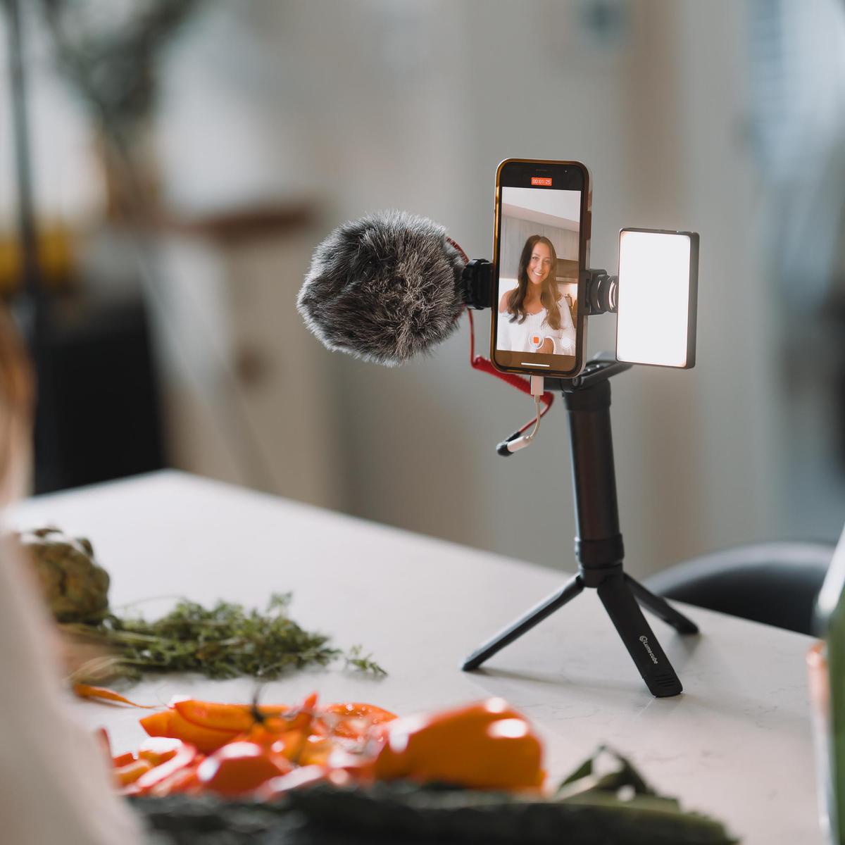 A smartphone on a tripod with lights attachment from Lume Cube.