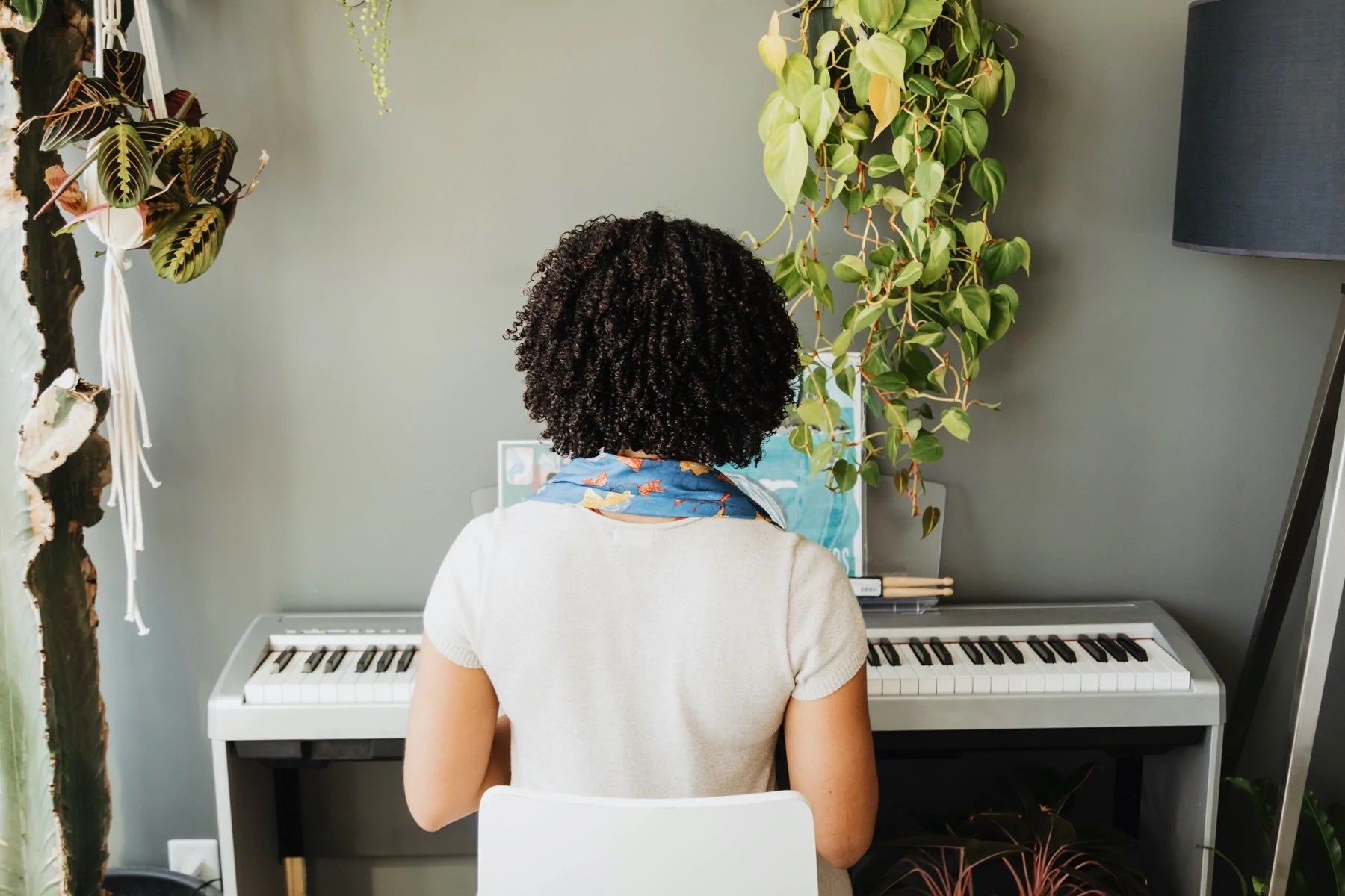 A person sits playing a piano