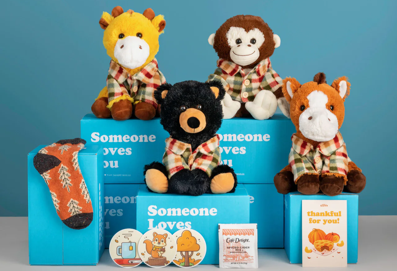 Cheerful soft toys sit on top of boxes that read “Someone loves you.”