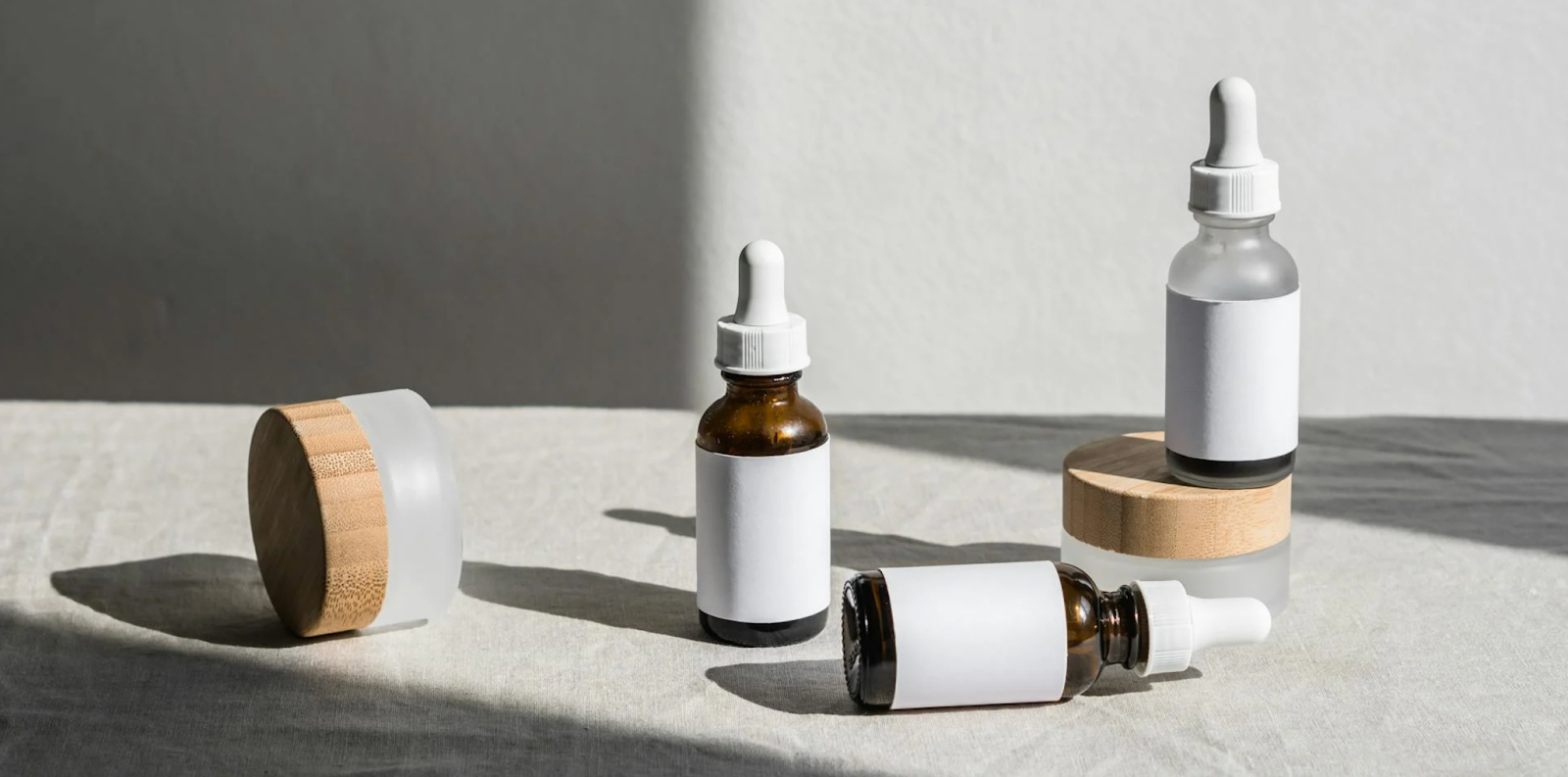 A selection of glass tinctures and small pots with white labels.