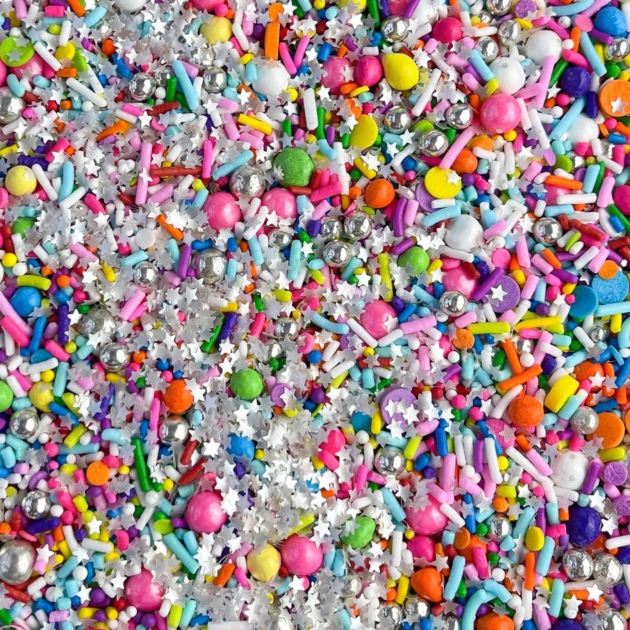 An image of a sprinkle medley with colorful balls and silver stars