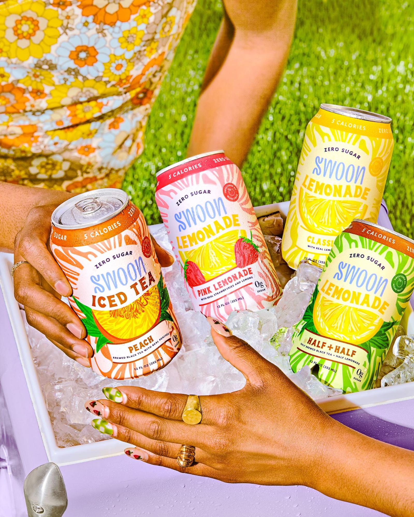 A cooler filled with ice and packed with four different ice teas by Swoon. 