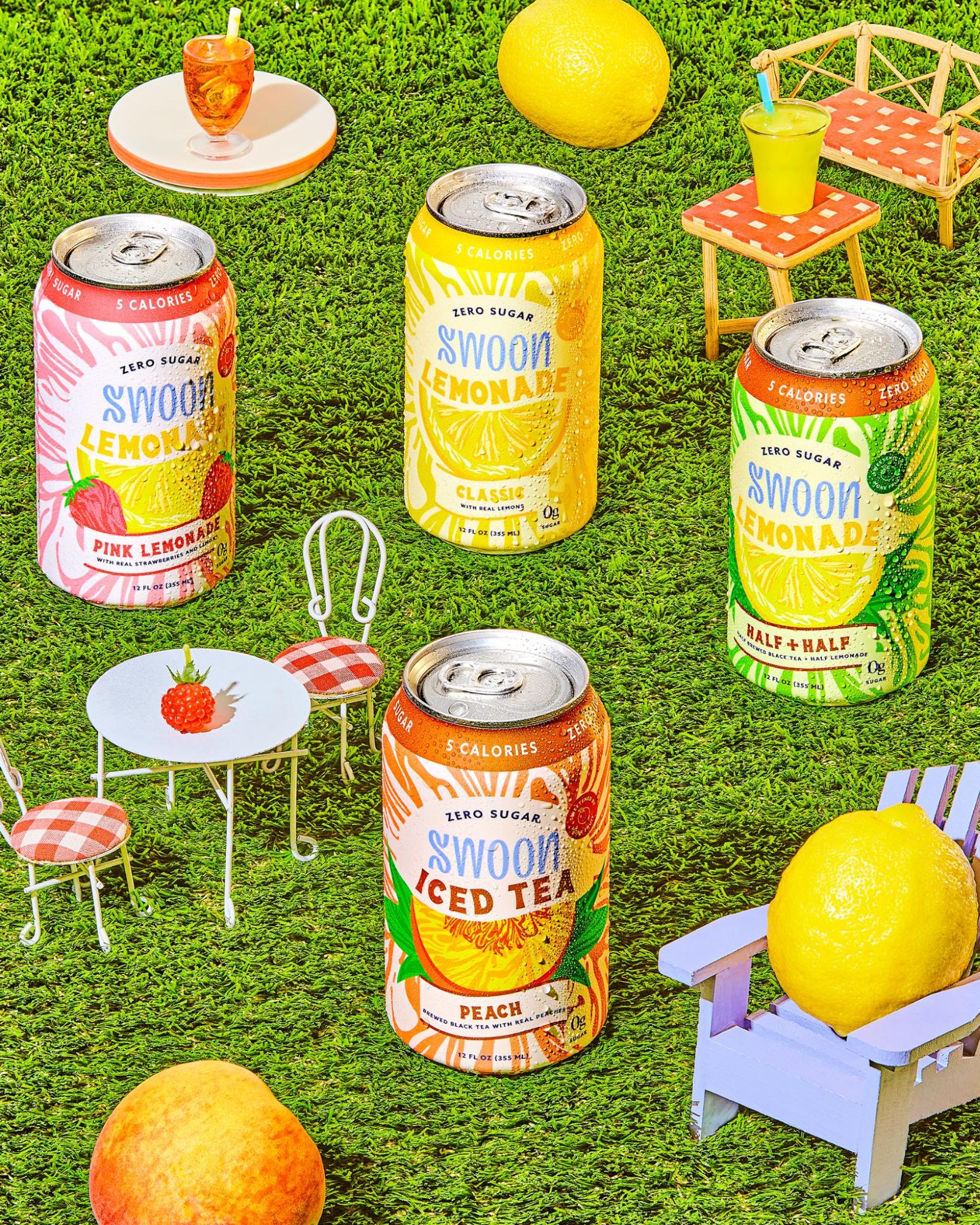  Four different beverages by Swoon are displayed against a grass background. 