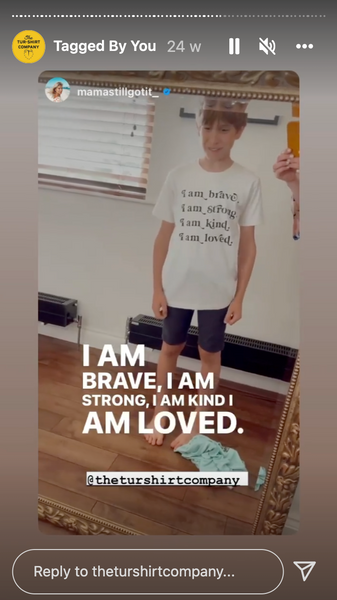 Video screenshot of a young child wearing a t-shirt.