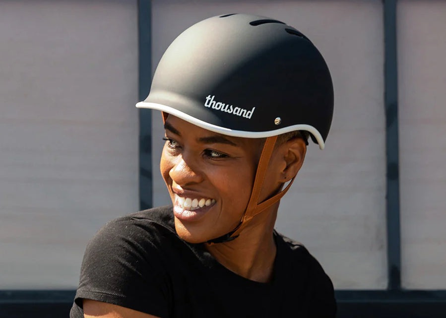 Woman in a bike helmet looks over her shoulder