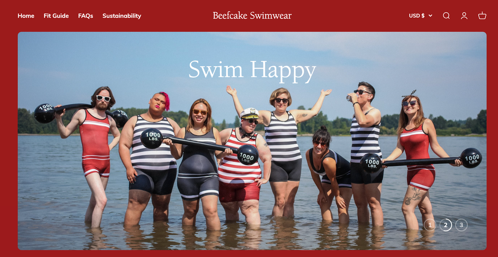 Group of swimwear models in shallow water posing with fake barbells, sunglasses, and beverages.