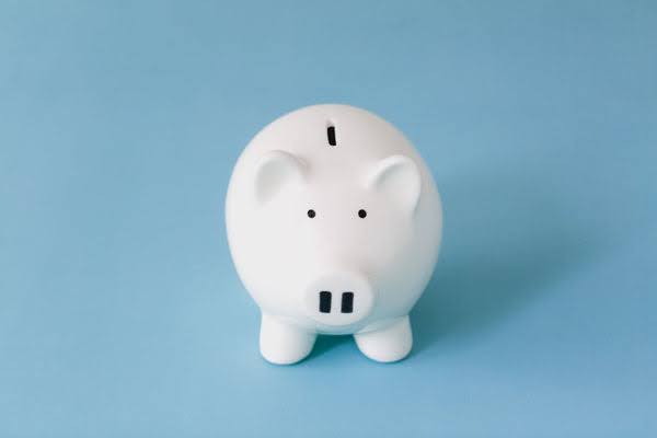 A white piggy bank on a blue background.