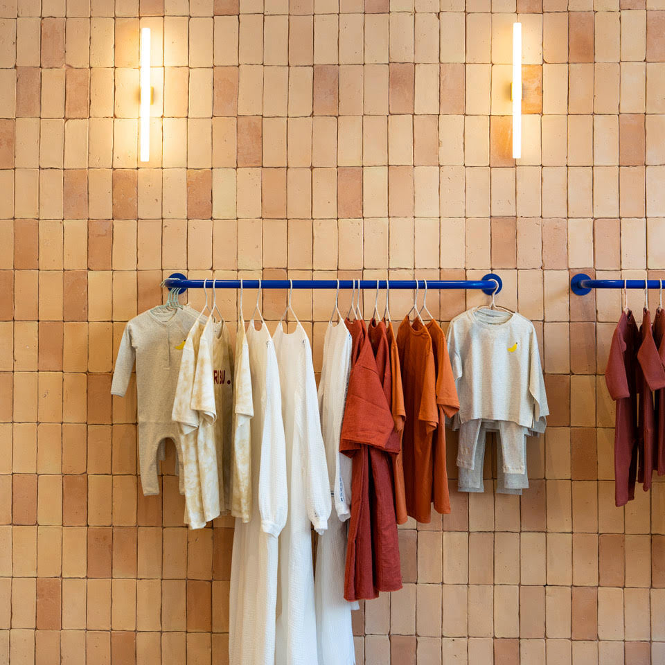  An array of clothing on racks within the Tajinebanane retail store.