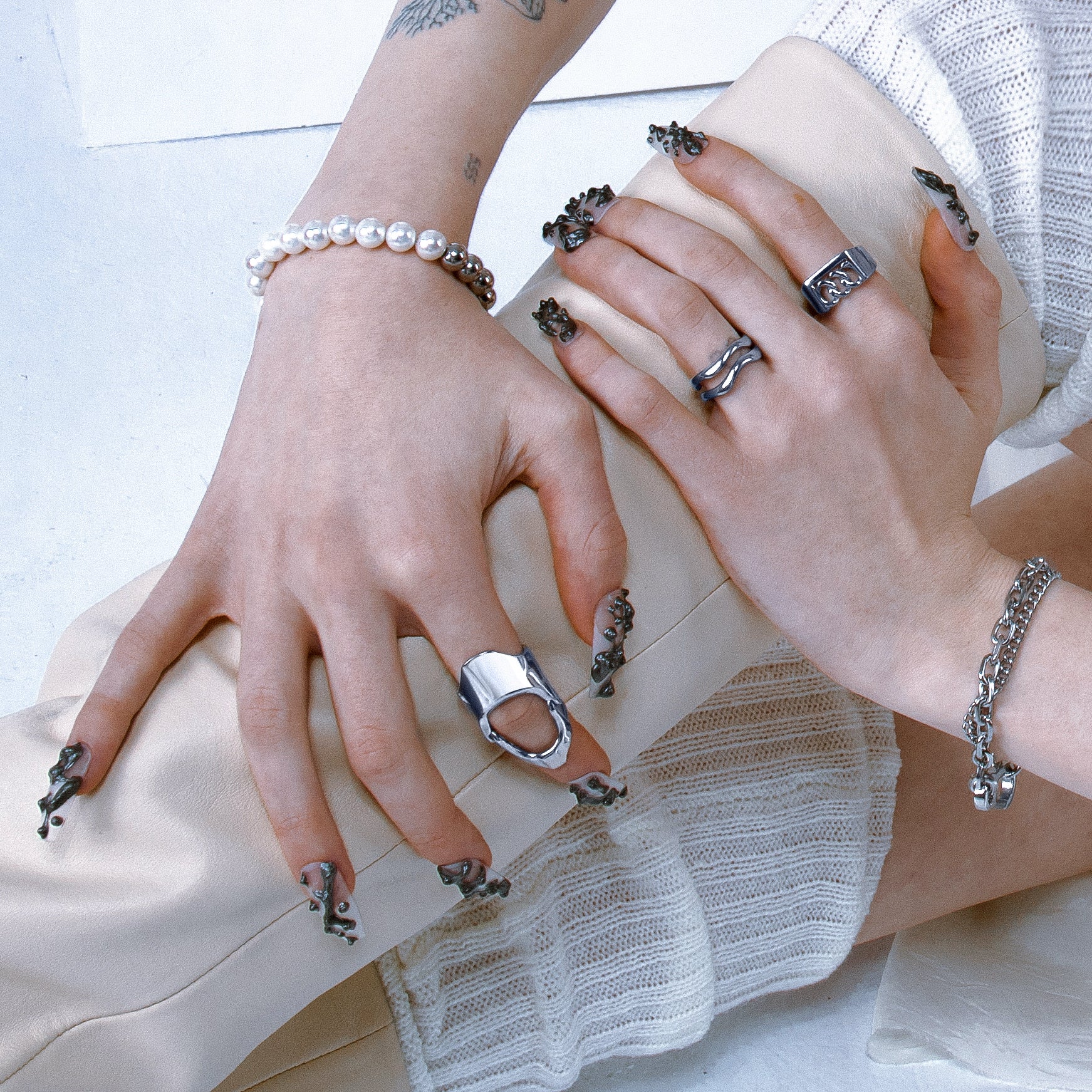 A set of hands shows wearing Vitaly rings and bracelets.