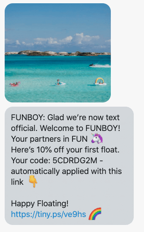 An SMS message includes an image of a tropical beach and a discount code.