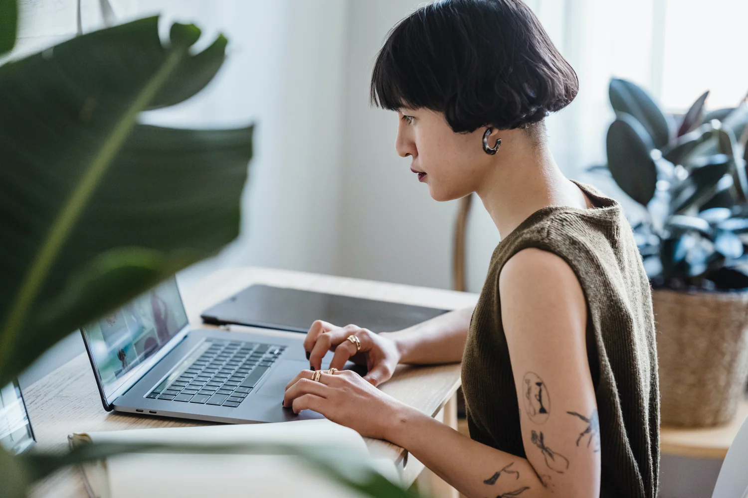 A woman types on a laptop in a home office