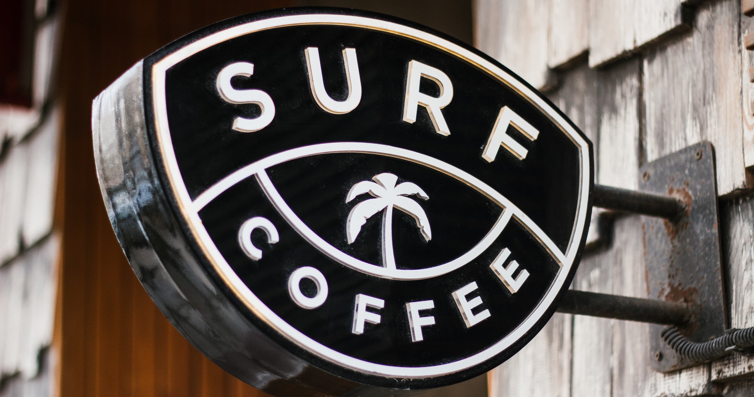 A large outdoor sign attached to a building reads "Surf Coffee"