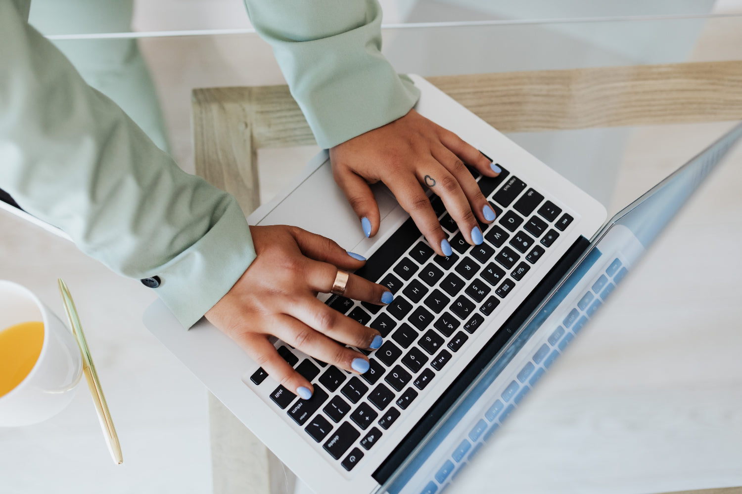 Close up of feminine hands typing on a laptop