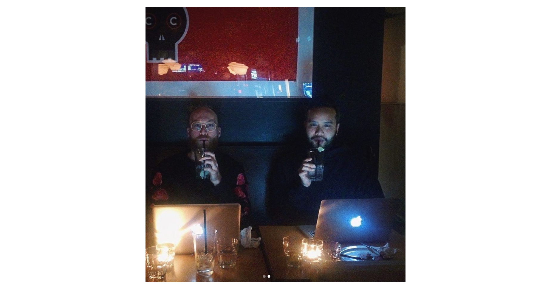 Phil and Armand on their laptops at a bar working from the early days
