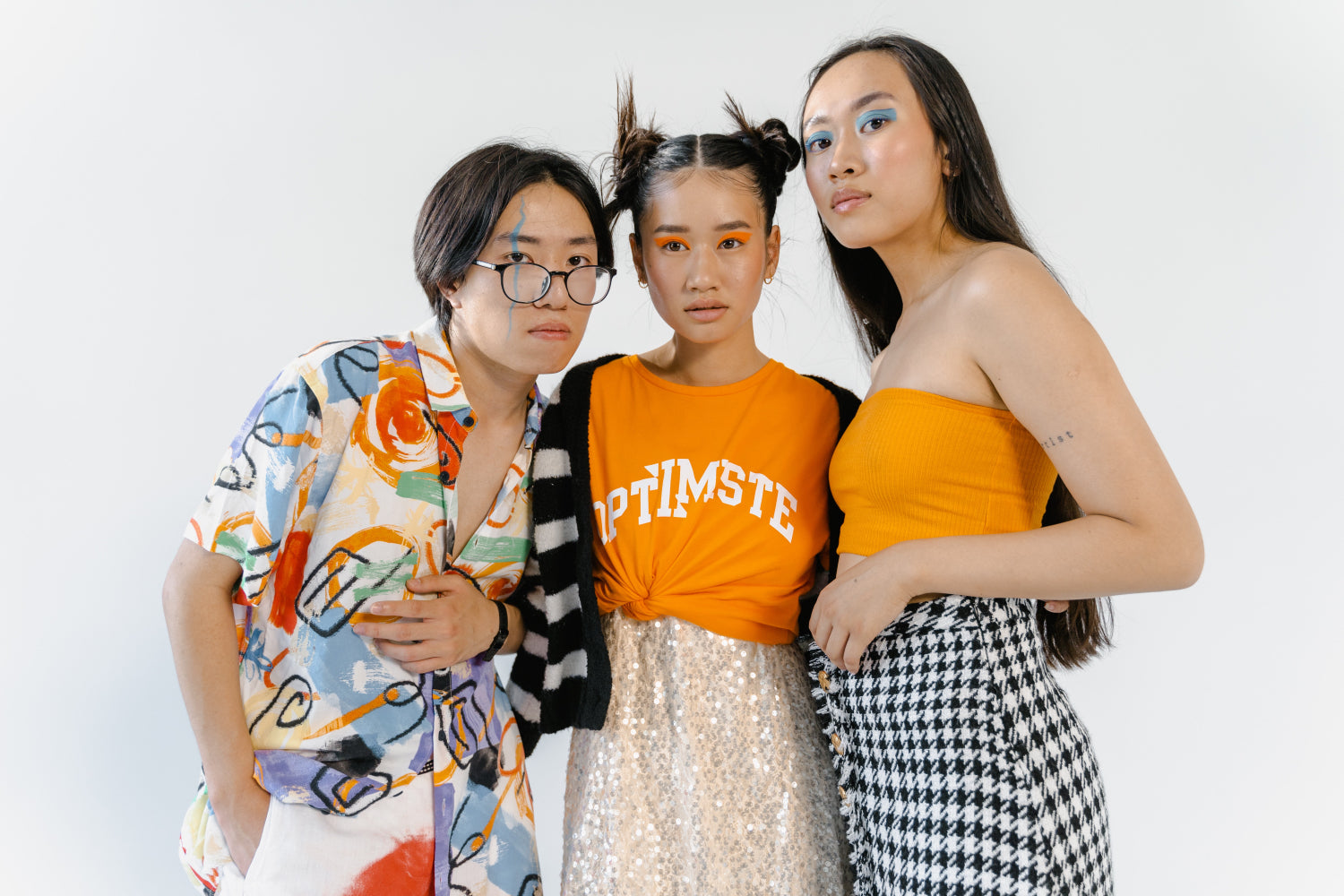 Three youths model contemporary clothing