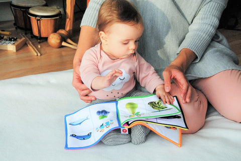 a baby reading a picture book