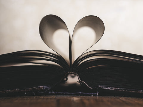 pages of a book curled and tucked into a heart shape