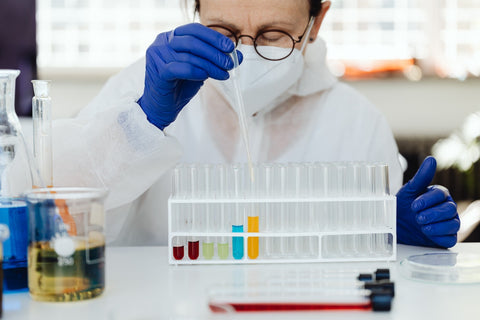 scientist working in a lab using a dropper