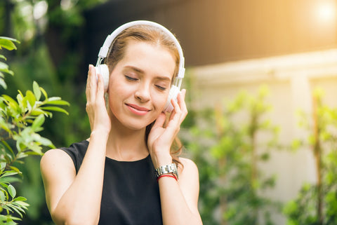 person looking peaceful as they listing to music in headphone